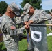 OSW US Army CSM Sablan and US Air Force Chief Master Sgt. Robinson award a streamer to Delta company