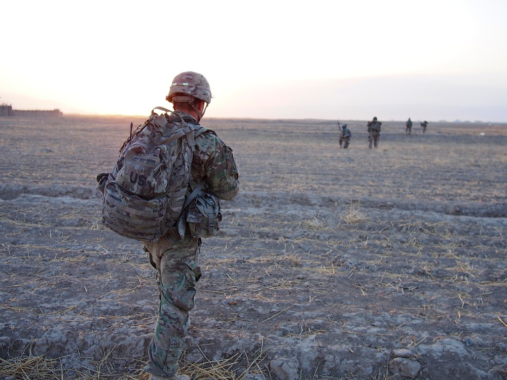 Sgt. 1st Class Richards surveys his platoon as they conduct a dismounted patrol outside of FOB Kunduz