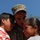 81st Civil Affairs Battalion welcome home ceremony A U.S. Army soldier in MultiCam/OCP camouflage uniform is embracing two children, likely his son and daughter, in an emotional moment. The soldier's name tape reads 'SOSTRE' and he wears a Major's oak leaf cluster insignia on his patrol cap. The girl on the right appears to be crying, suggesting this may be a deployment farewell or homecoming reunion.