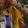 81st Civil Affairs Battalion welcome home ceremony Two soldiers in US Army Operational Camouflage Pattern (OCP) uniforms are handling a colorful military unit guidon or streamer with multiple campaign streamers in yellow, red, green, orange, and purple colors. A metallic finial or spearhead is visible at the top of the staff. The setting appears to be an outdoor military ceremony or formation.