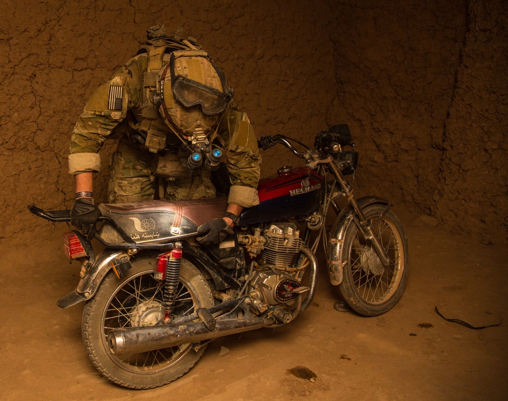 Coalition force members conduct operation in Helmand province