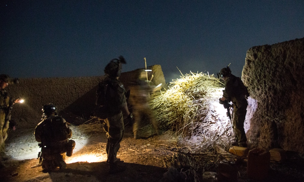 Coalition force members conduct operation in Helmand province