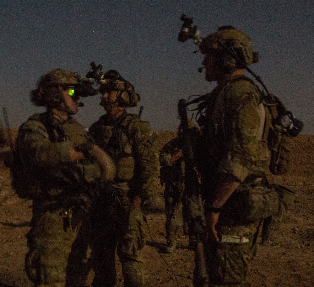 Coalition force members conduct operation in Helmand province