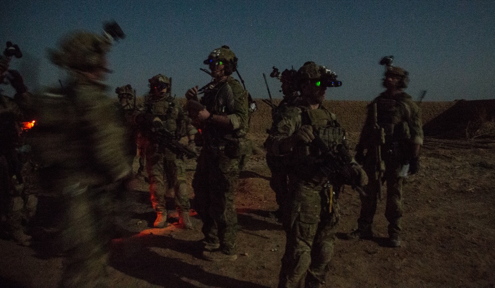 Coalition force members conduct operation in Helmand province