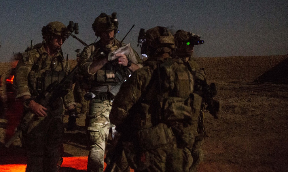 Coalition force members conduct operation in Helmand province