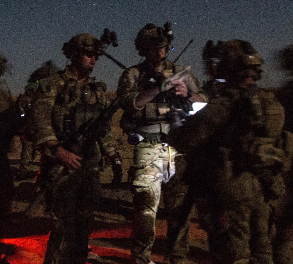 Coalition force members conduct operation in Helmand province