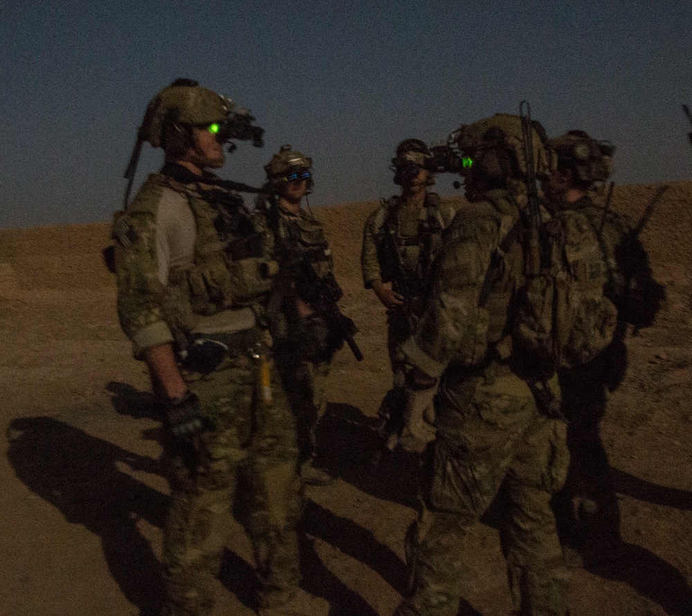 Coalition force members conduct operation in Helmand province