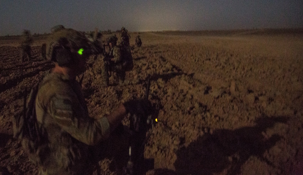 Coalition force members conduct operation in Helmand province