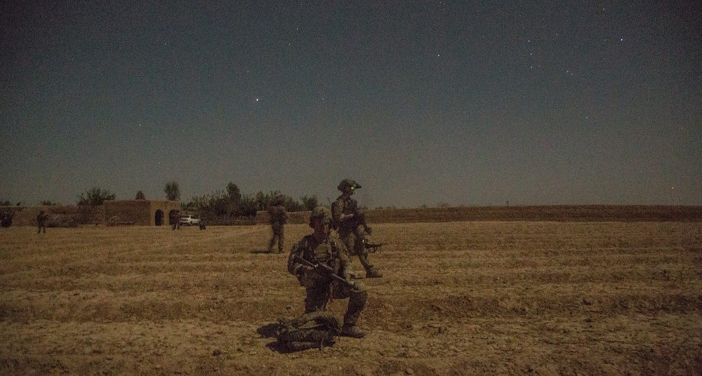 Coalition force members conduct operation in Helmand province