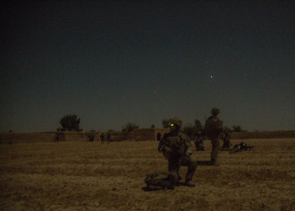 Coalition force members conduct operation in Helmand province