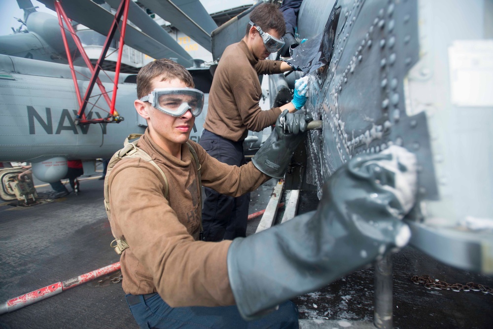 Washing an MH-60S Sea Hawk helicopter