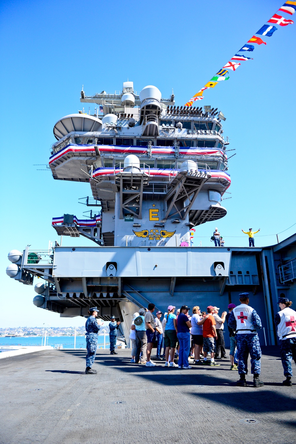 Guests ride an aircraft elevator to the flight deck aboard the aircraft carrier USS Ronald Reagan (CVN 76)