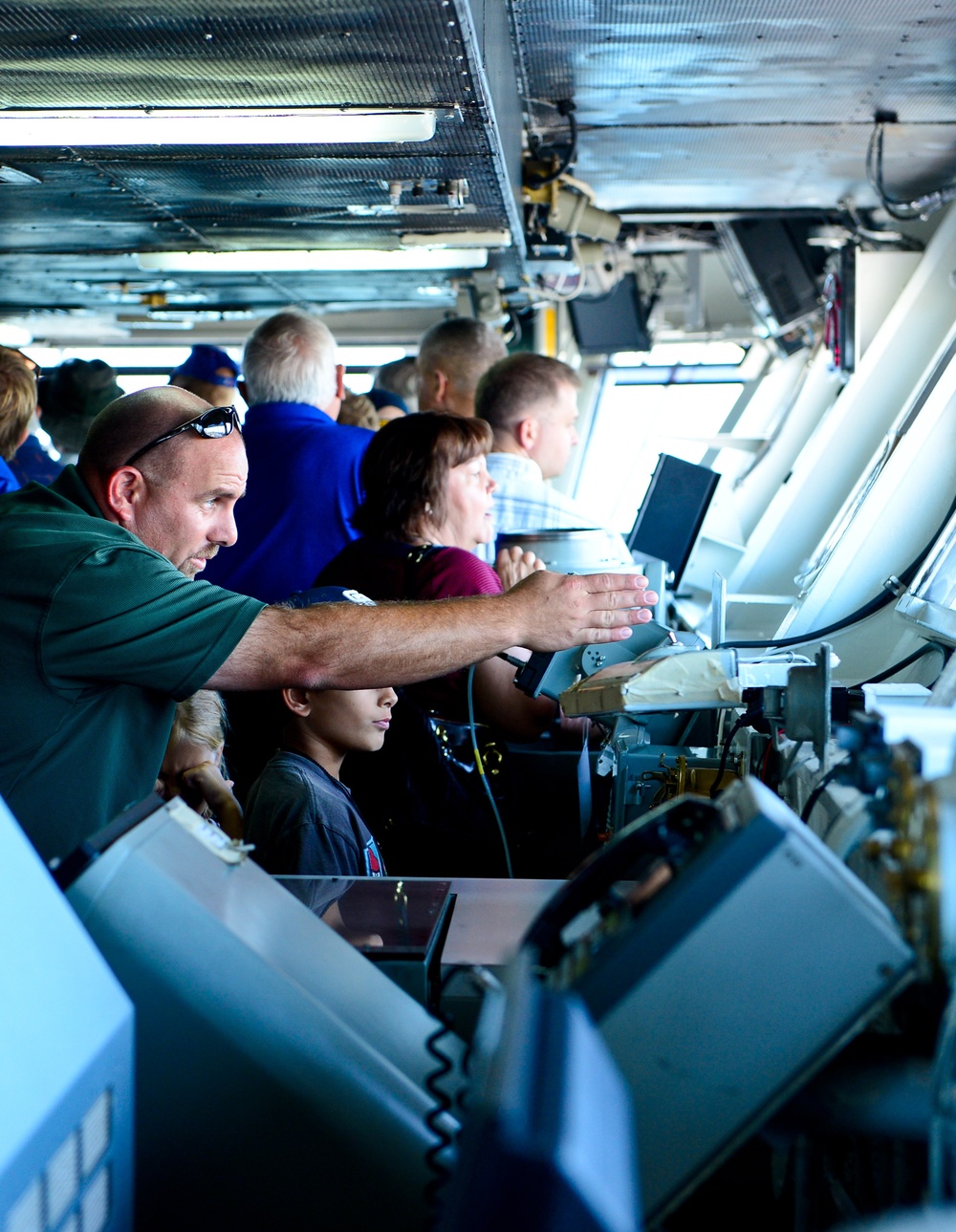 Guests tour the navigation bridge aboard the aircraft carrier USS Ronald Reagan (CVN 76)