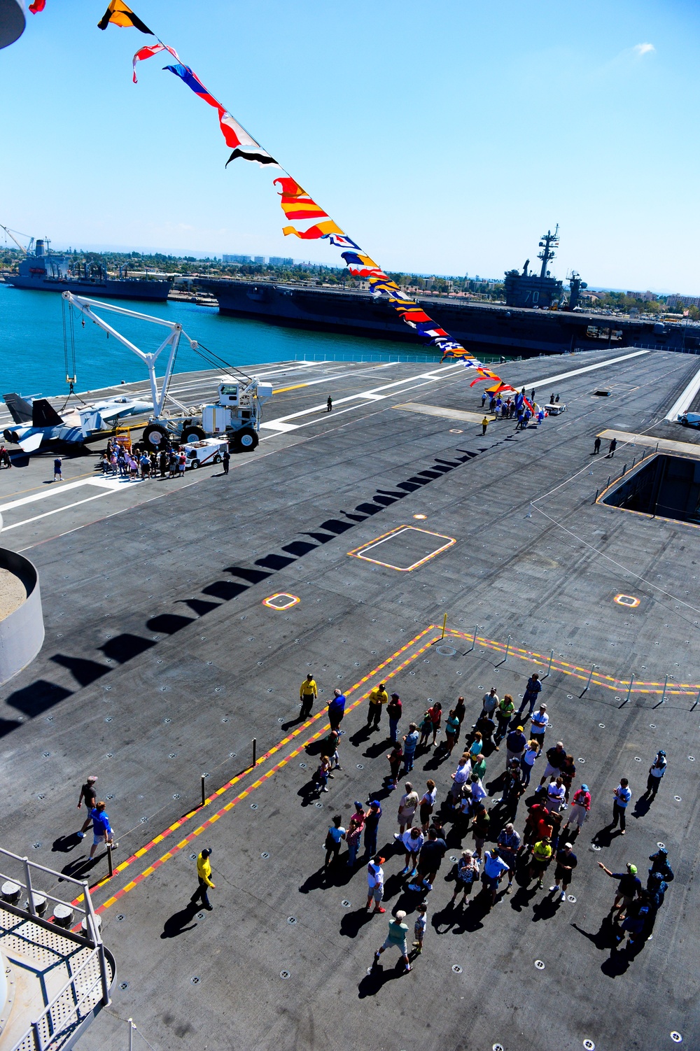 Guests tour the flight deck of the aircraft carrier USS Ronald Reagan (CVN 76)