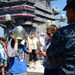 A guest touring the aircraft carrier USS Ronald Reagan (CVN 76) dons a firefighting helmet