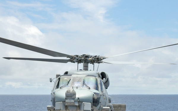 Helicopter takes off from USS Rentz