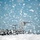 Flurry of foam released at Travis A U.S. Air Force military transport aircraft, identifiable as a C-17 Globemaster III, is parked on a flight line during a heavy snowstorm. Large snowflakes fill the foreground and sky, partially obscuring the aircraft. The image is taken from a low angle with snow accumulation visible in the immediate foreground.