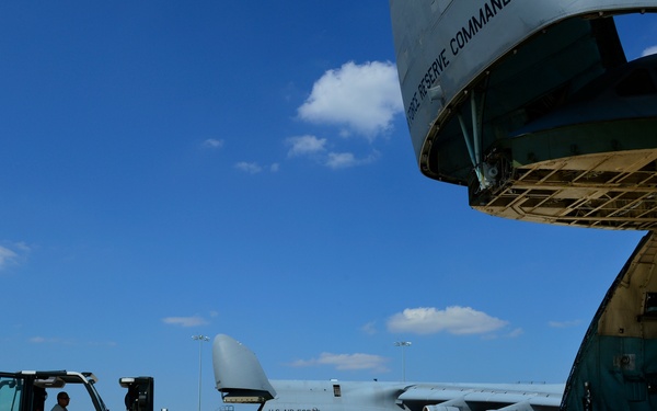 The 433 AMS and 356 AS work together to load a C-5A Galaxy