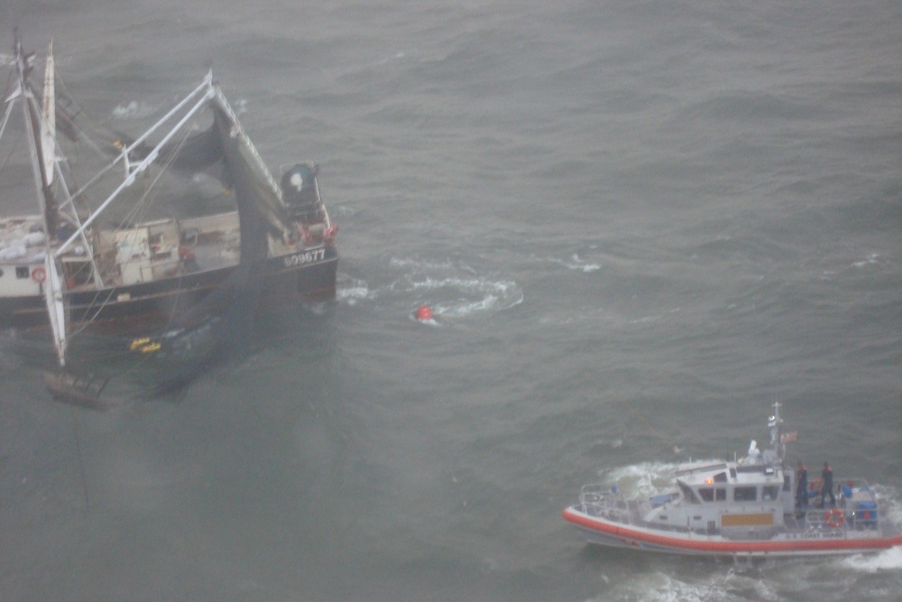 Coast Guard responds to 4 people on flooding boat