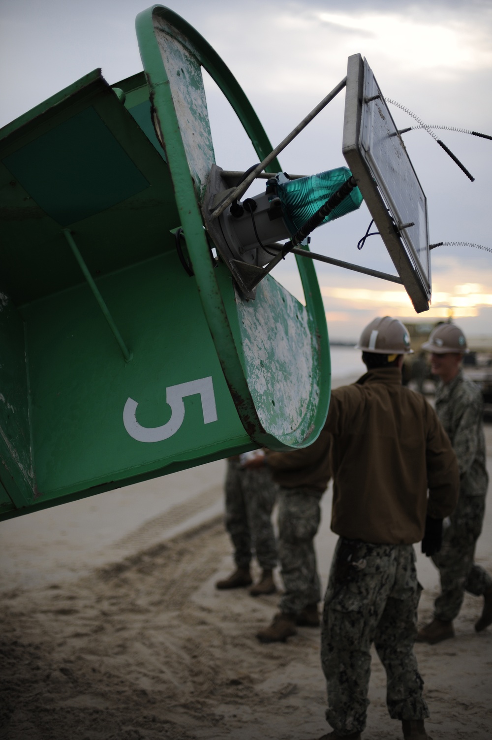 Coast Guard, Navy removes buoy from beach