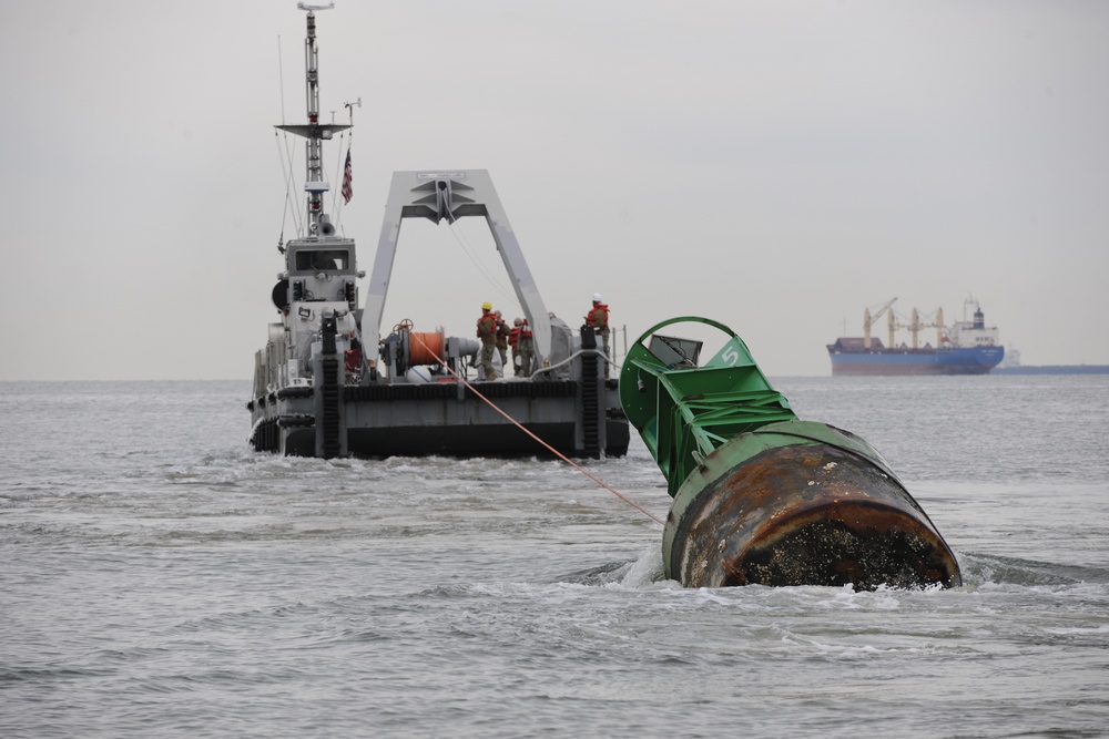 Coast Guard, Navy remove buoy from beach