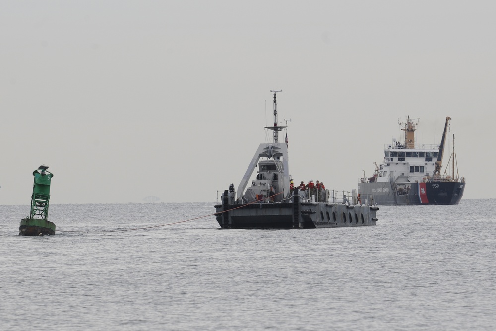 Coast Guard, Navy remove buoy from beach