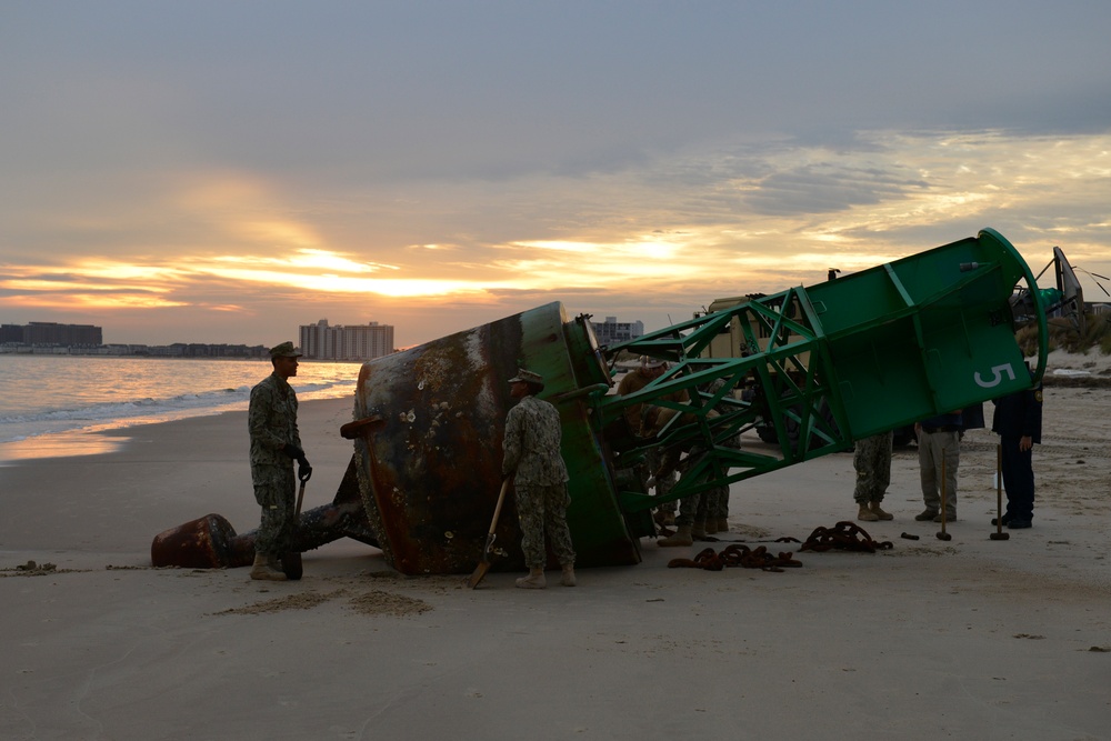 Coast Guard, Navy remove buoy from beach