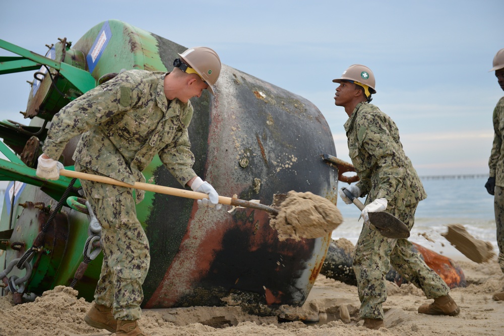 Coast Guard, Navy remove buoy from beach