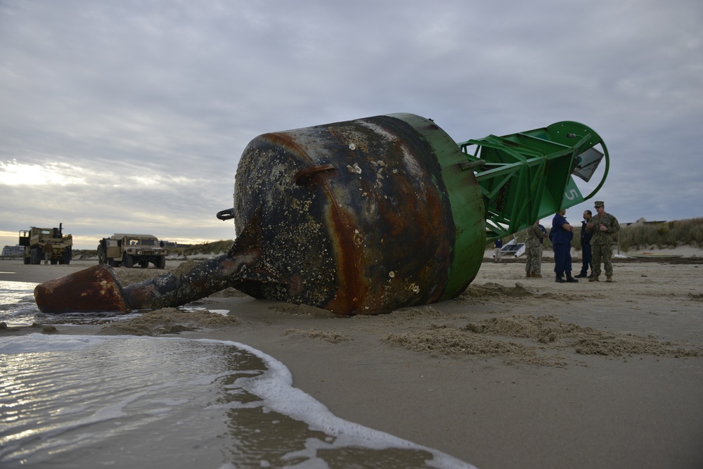 Coast Guard, Navy removes buoy from beach