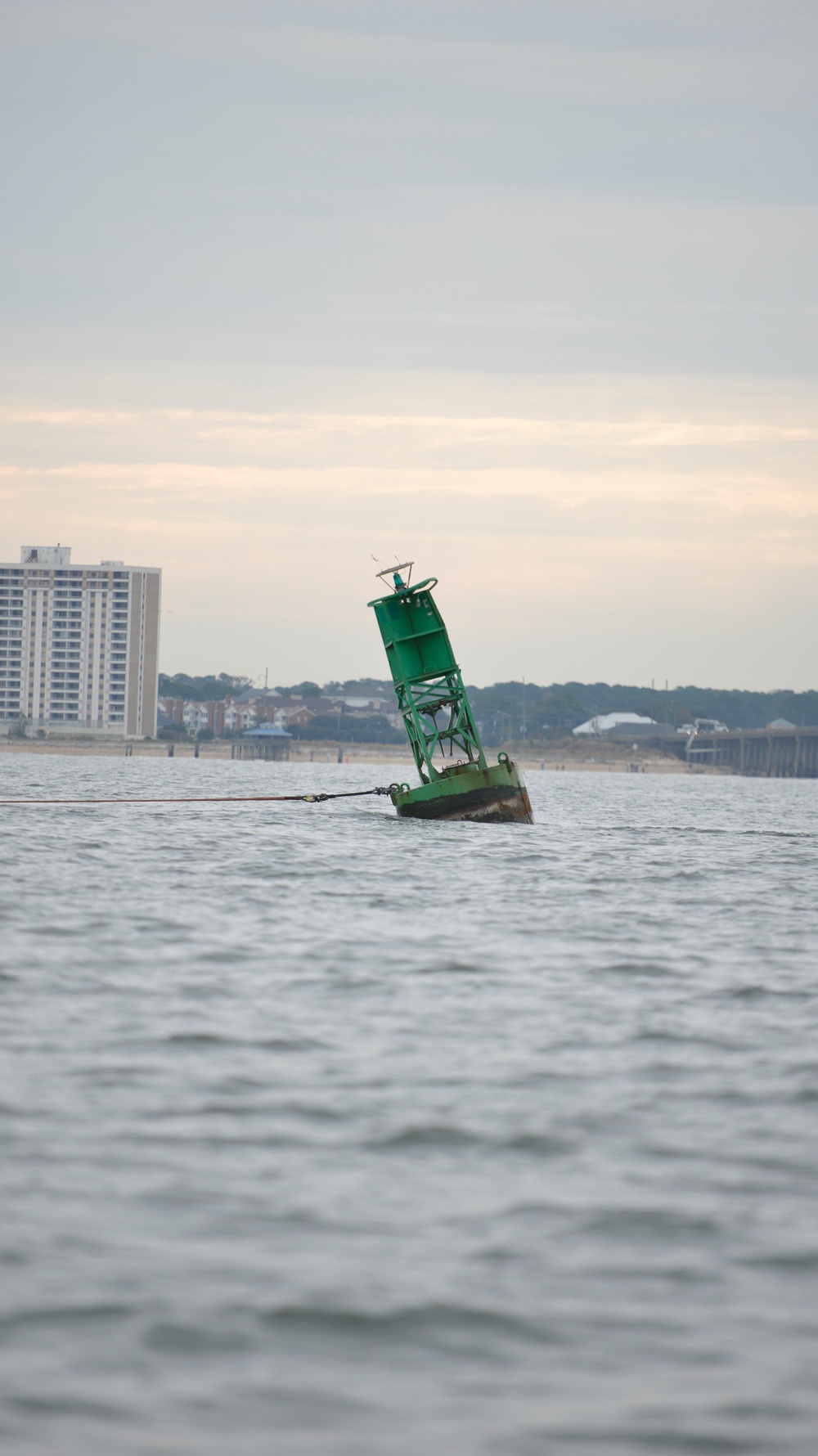 Coast Guard, Navy retrieve aground buoy from Chic's Beach, Va.