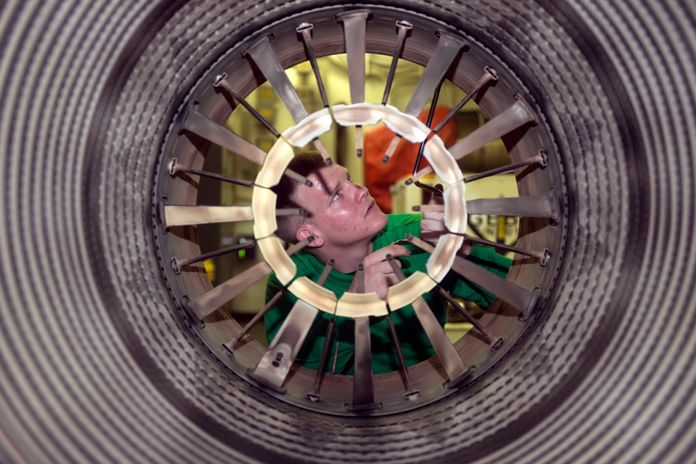 USS Harry S. Truman sailor performs aircraft maintenance