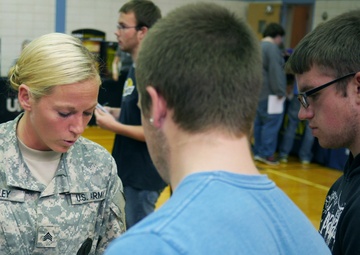 Indiana National Guard Recruiter of the Year, Sgt. Brooke Bailey, speaks with students about the benefits the National Guard offers at a career fair in Muncie, Ind. Sgt. Bailey is the first female recruiter to be named &quot;Recruiter of the Year&quot; in Indiana.