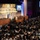 A large formal gala or awards dinner hosted by AUSA (Association of the United States Army) in 2013, with the tagline 'Voice for the Army, Support for the Soldier' displayed on a prominent backdrop. A speaker is addressing hundreds of formally dressed attendees seated at round banquet tables in a large convention hall. The speaker is displayed on multiple large video screens throughout the venue.