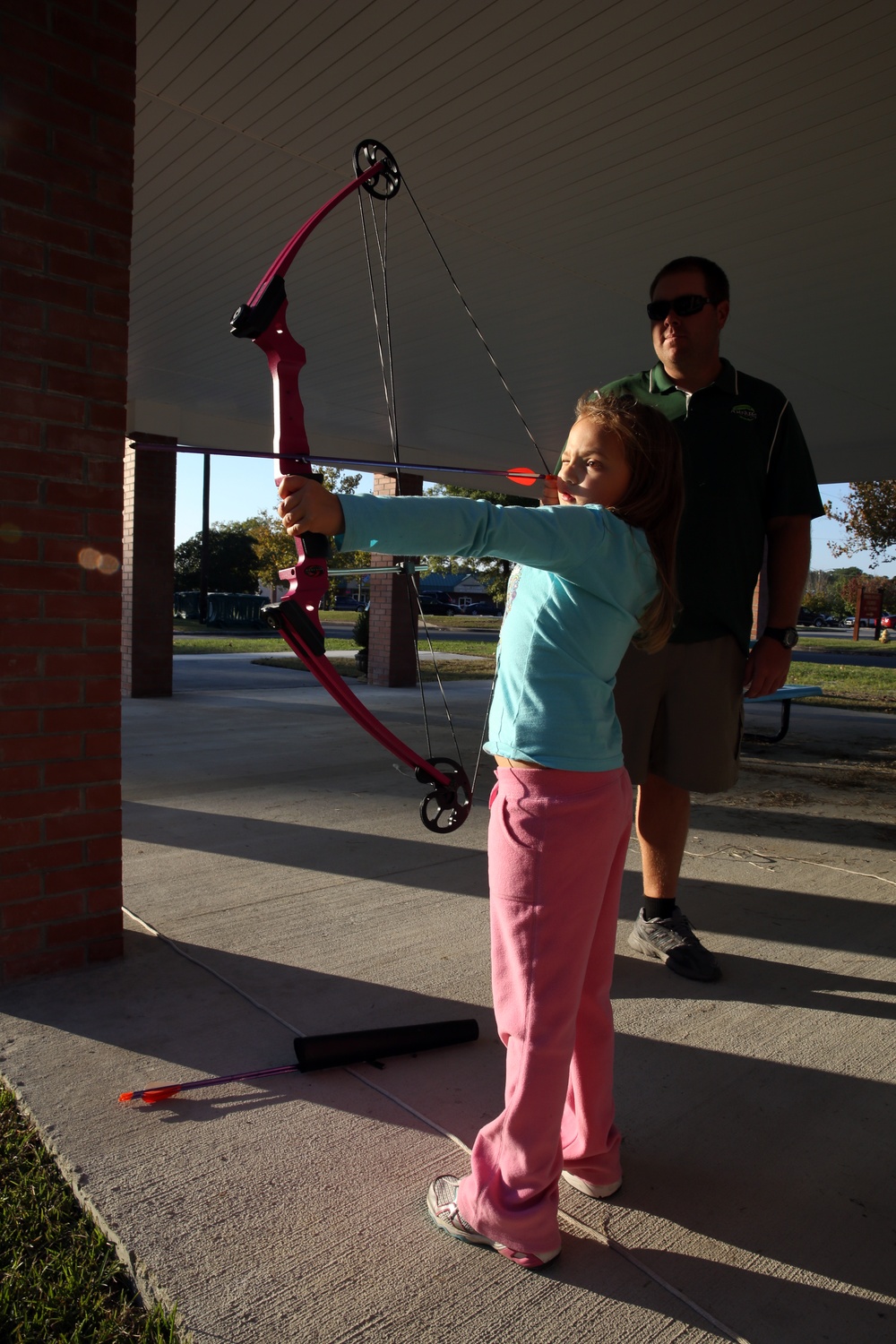 Military children learn archery fundamentals