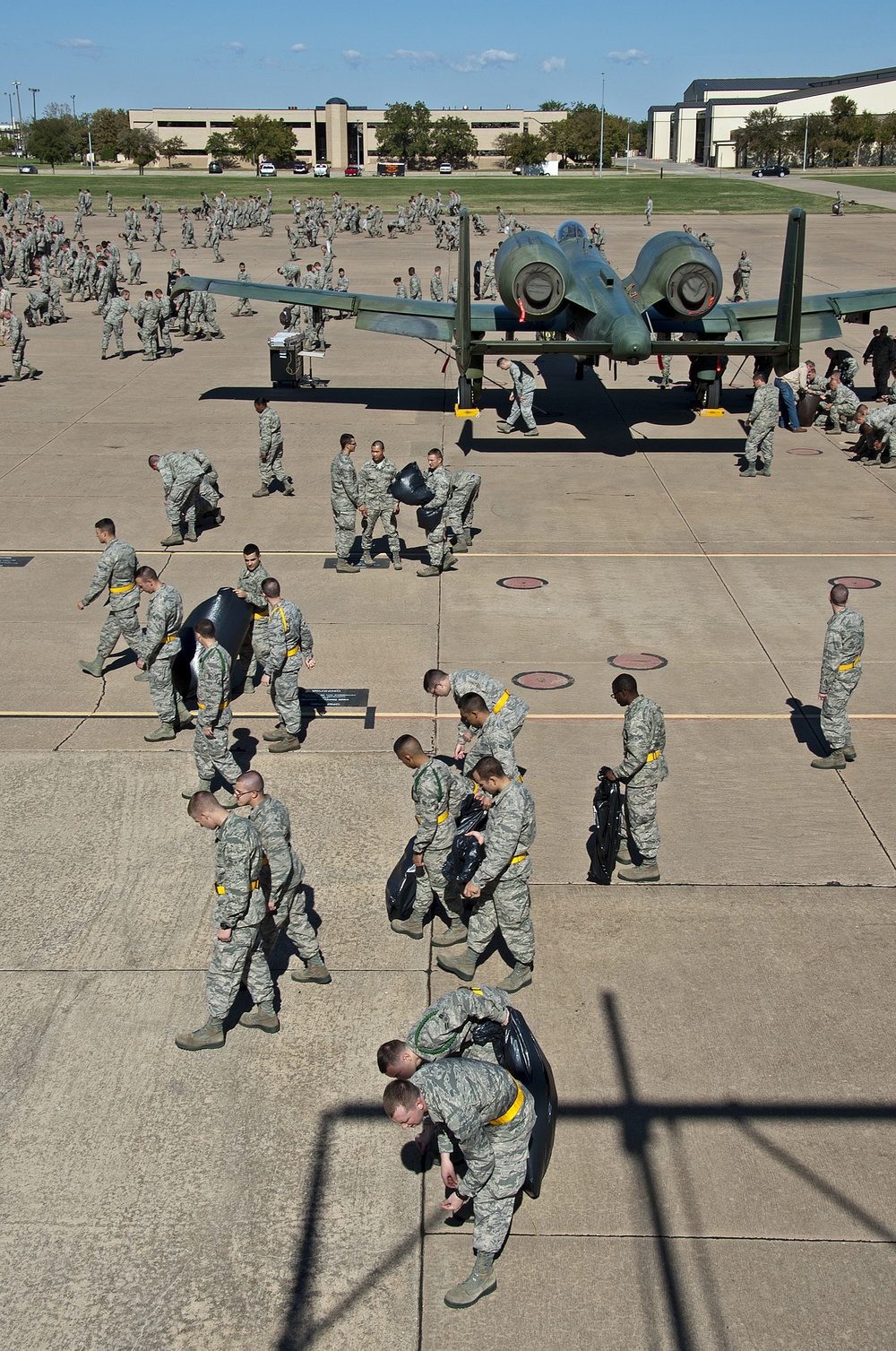 Airman and civilian employees, perform a Foreign Object Debris (FOD) Walk