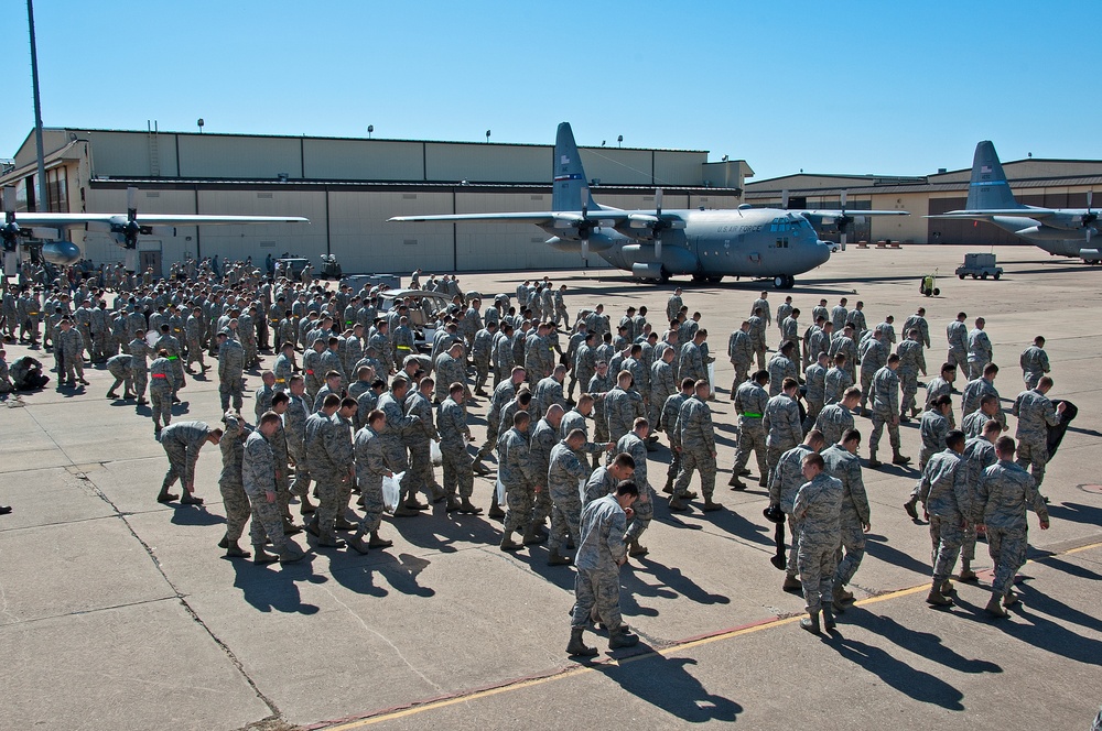 Airman and civilian employees, perform a Foreign Object Debris (FOD) Walk