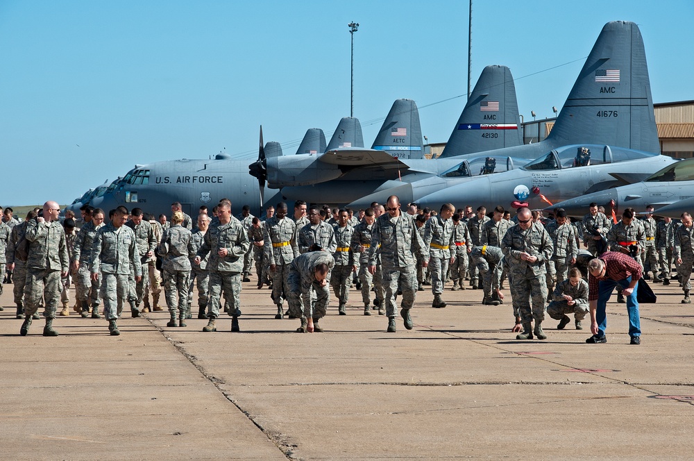 Airman and civilian employees, perform a Foreign Object Debris (FOD) Walk