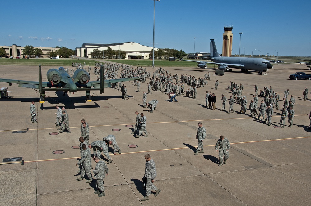 Airman and civilian employees, perform a Foreign Object Debris (FOD) Walk