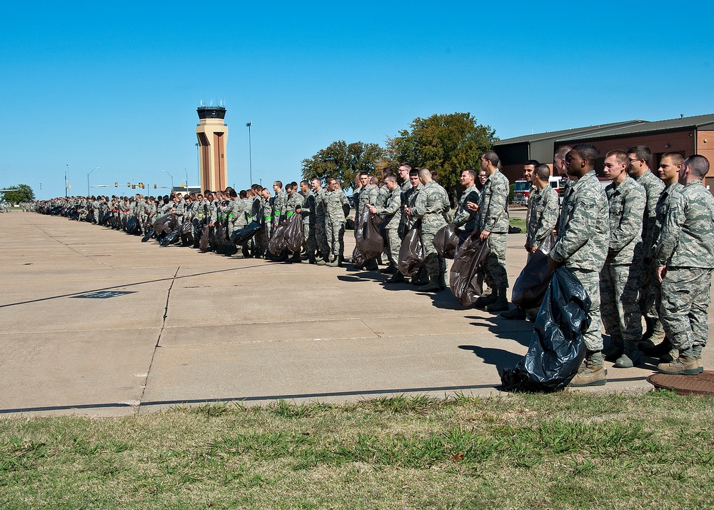 Airman and civilian employees, perform a Foreign Object Debris (FOD) Walk