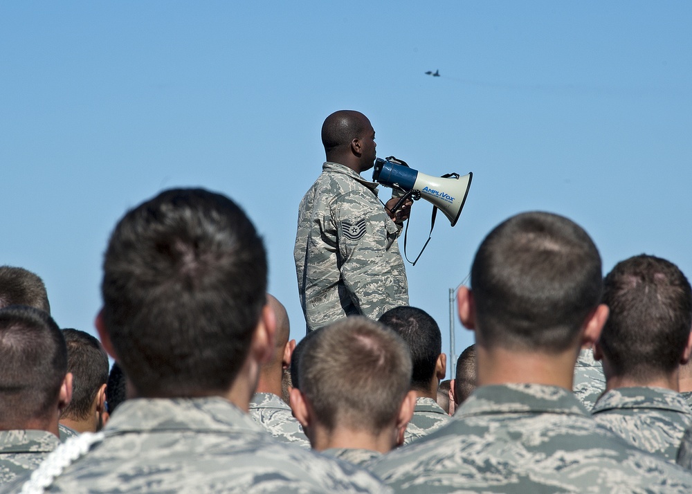 Airman and civilian employees, perform a Foreign Object Debris (FOD) Walk