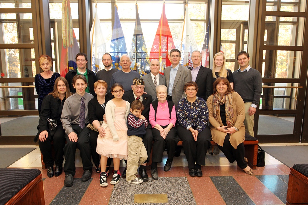 WWII Veteran poses for a photo with his family before award ceremony