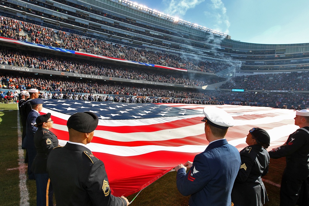 100 service members unfurl American flag at Chicago Bears game