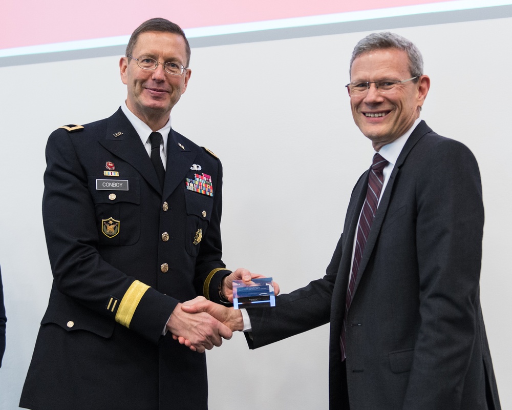 Maj. Gen. David Conboy and Paul K. Kearns shake hands after Veterans Day speech