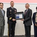 Paul Kerns presents Maj. Gen. David Conboy  a plaque with Alberto Camargo and Andrea Viel