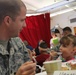 Soldiers help Thanksgiving come early for elementary school children