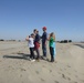 Visitors stand atop newly dredged river sand at the Antioch Dunes National Wildlife Refuge