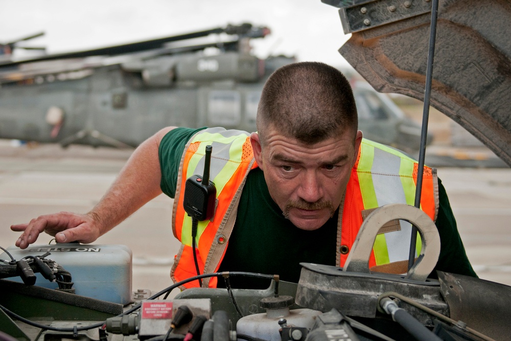 Joint inspections supervisor checks Humvee engine