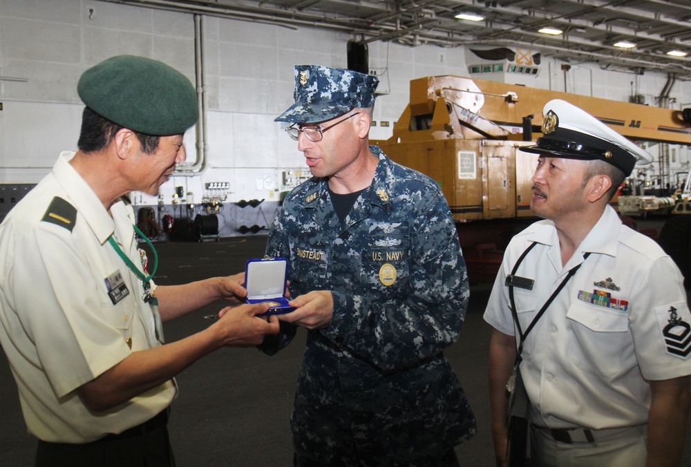 Japanes sailors tour USS George Washington