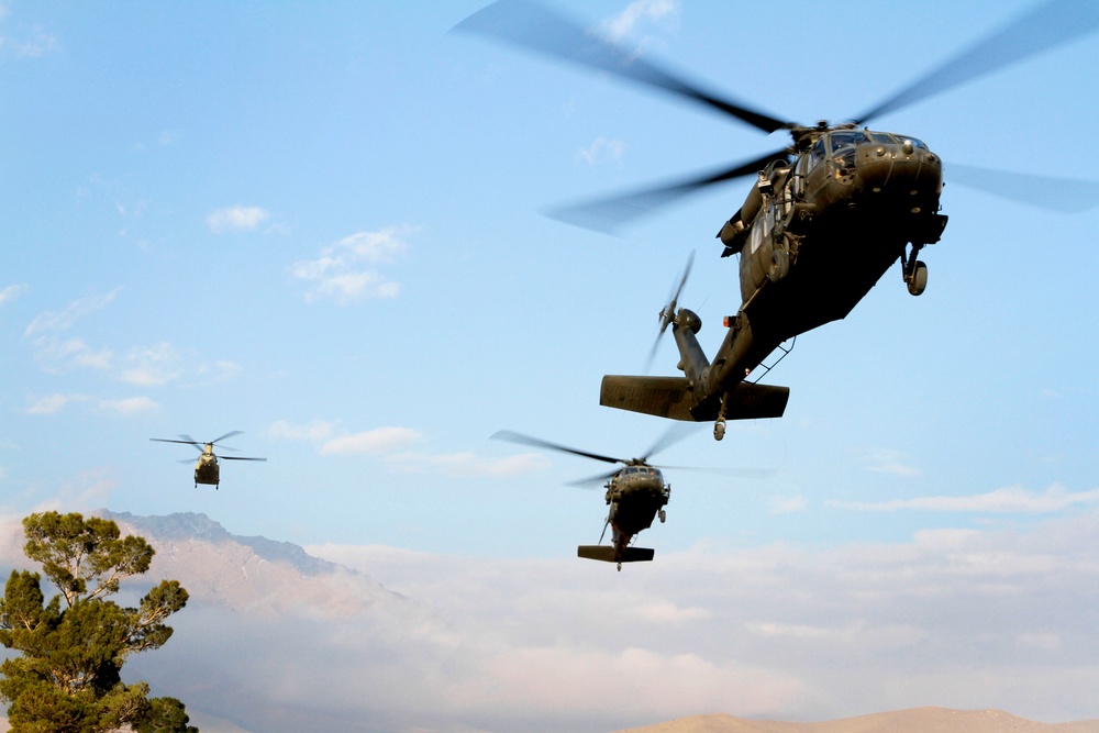 UH-60, CH-47 landing on Camp Commando