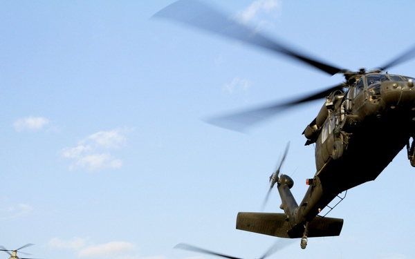 UH-60, CH-47 landing on Camp Commando